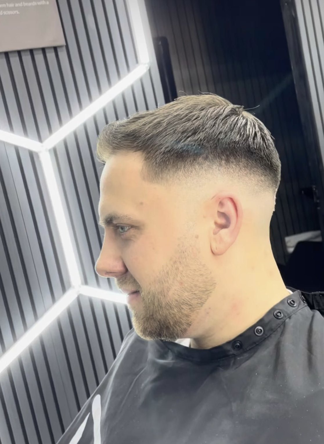 Textured crop with a mid skin fade and a neat beard line