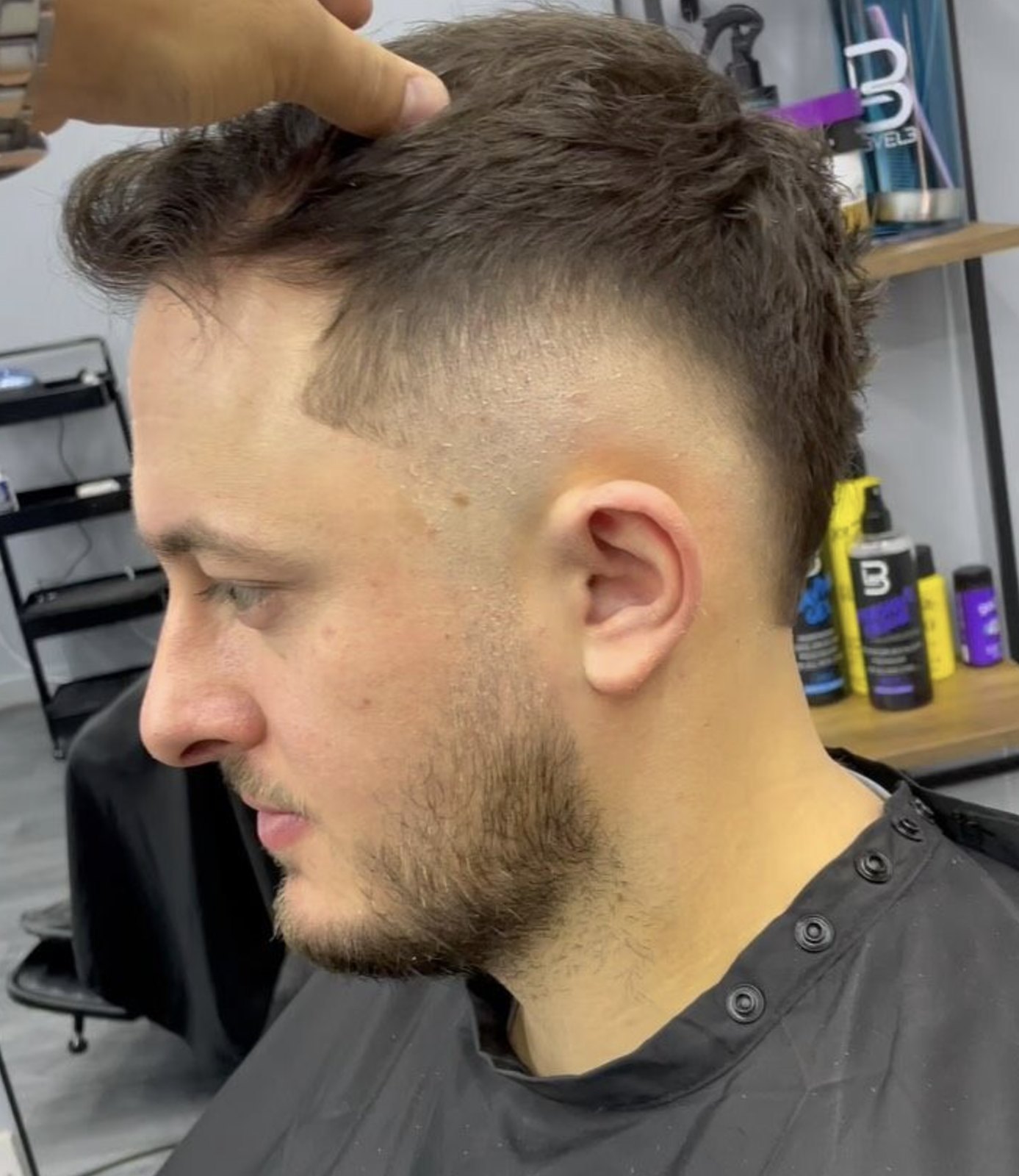 Fringe fade being finished, close-up of the blend around the ear