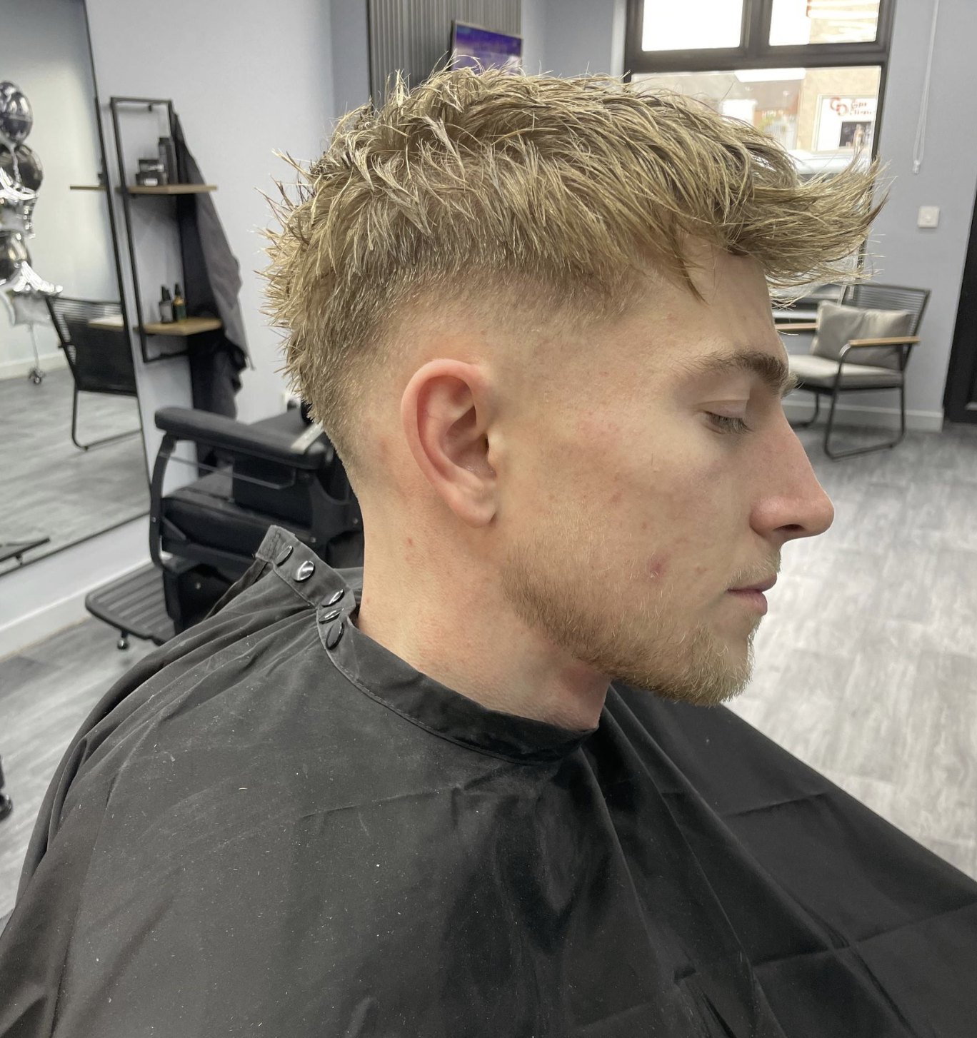 Blonde textured quiff with a fade