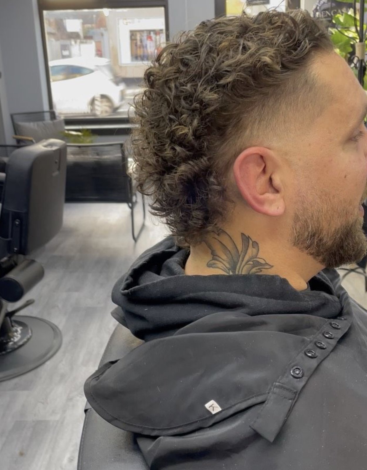Curly textured fade with tapered sides
